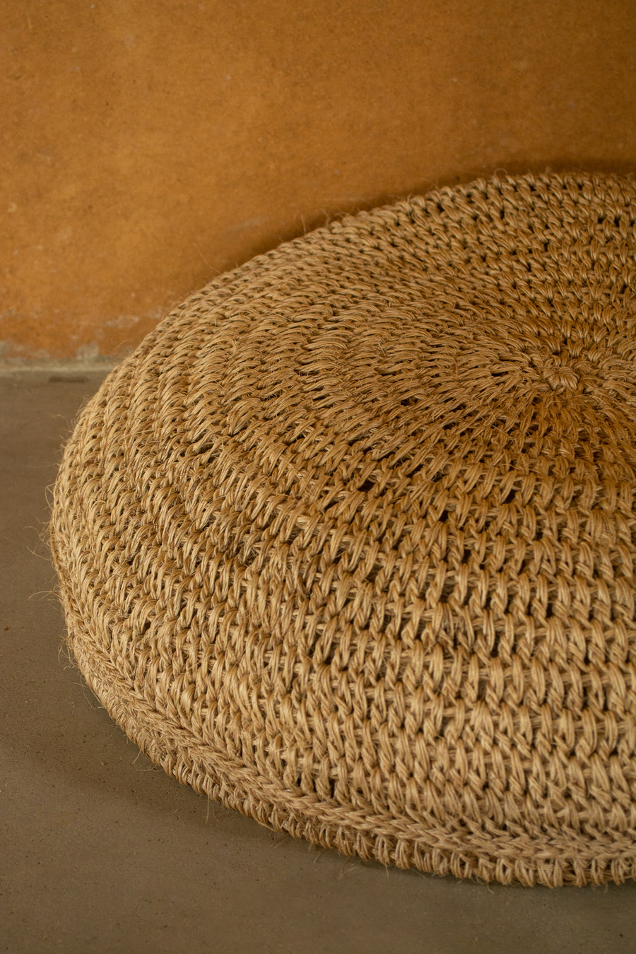 Natural fibre floor cushion.